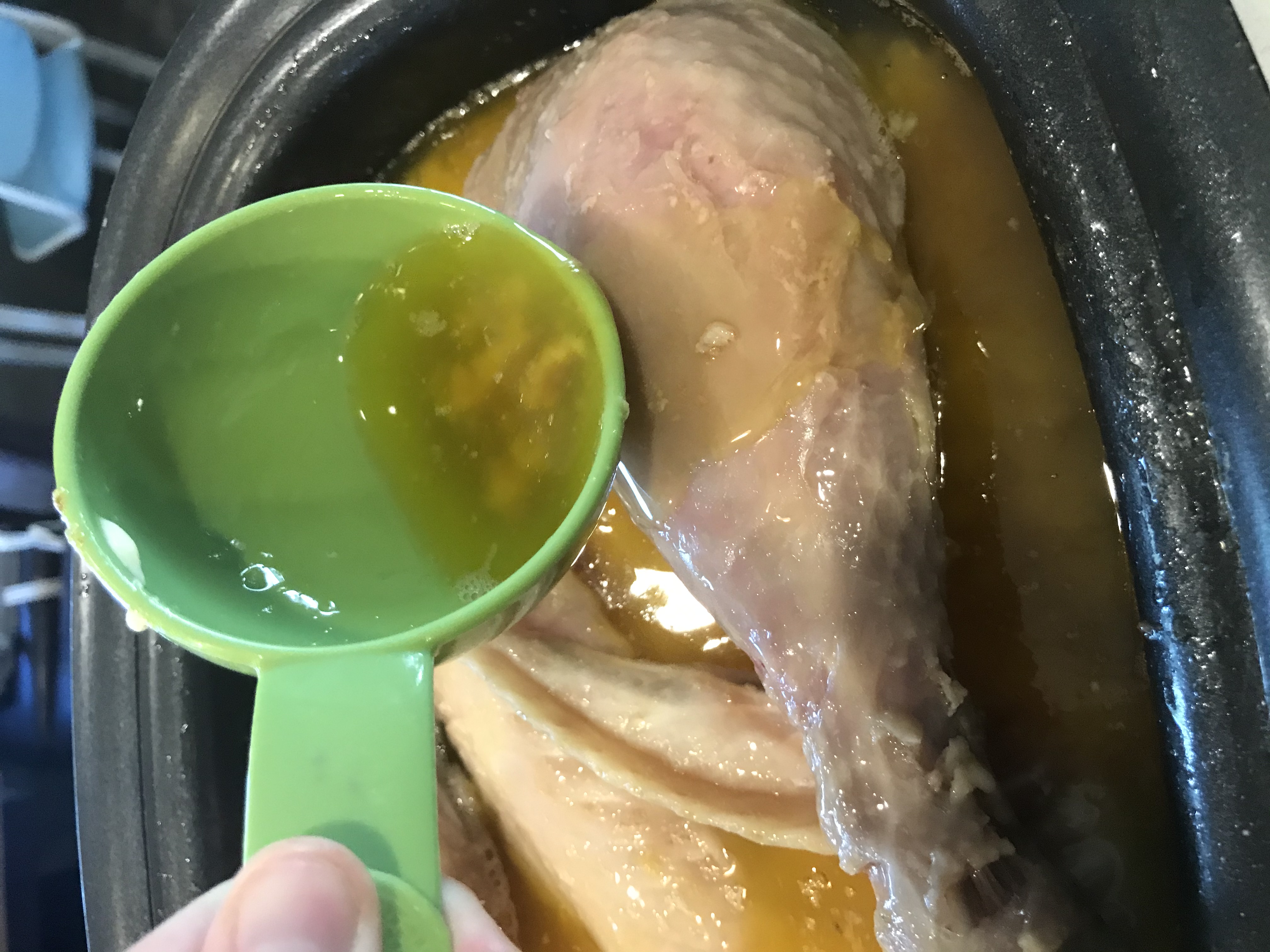 pouring broth over turkey