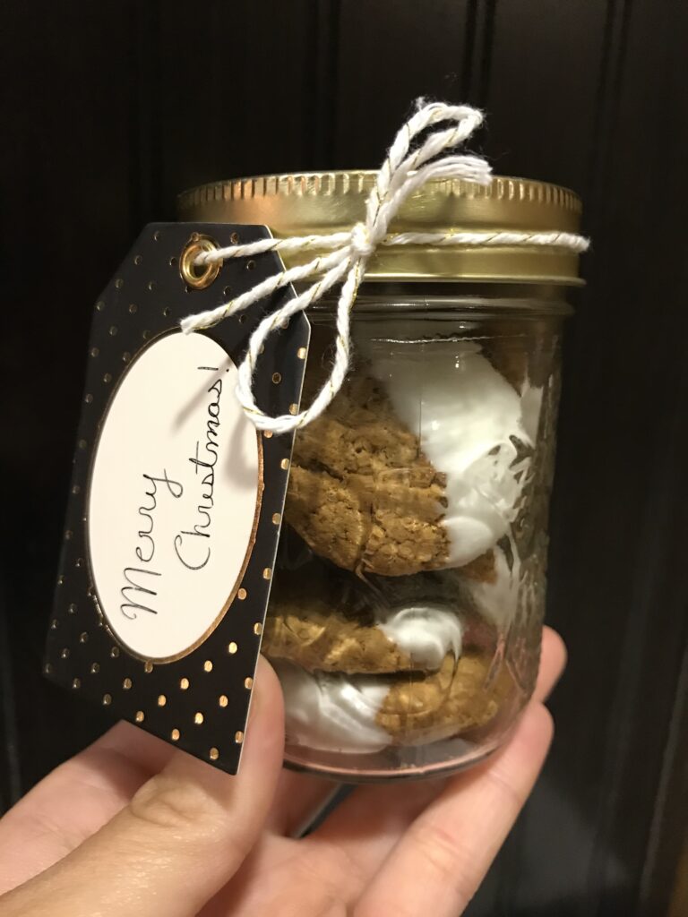 hand dip ginger snap cookies in jar